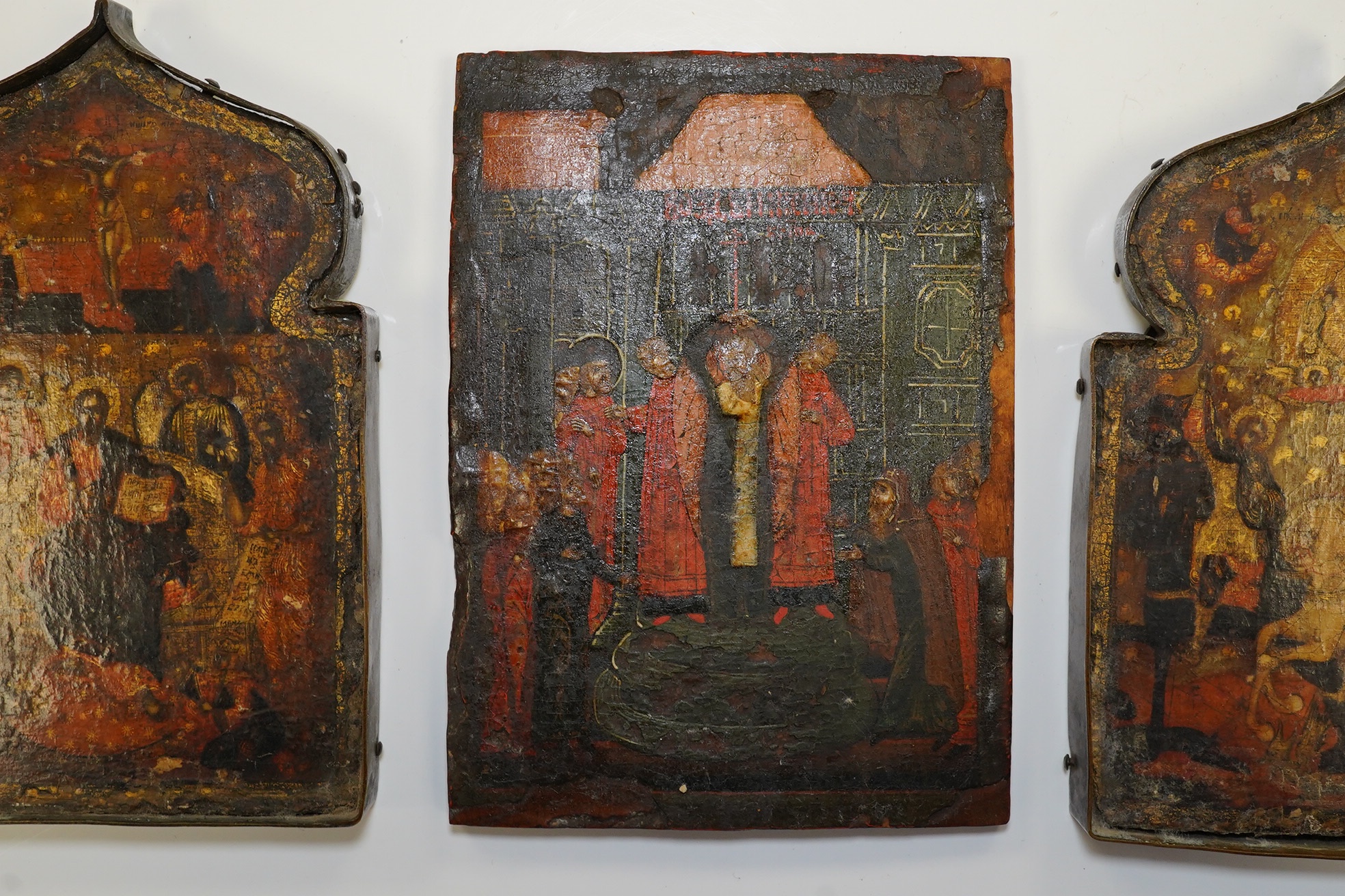 A pair of 17th century or later Russian painted wood icons, and another similar, 13.5 x 10cm. Condition - poor to fair